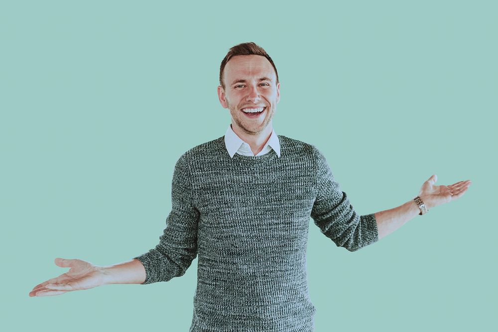 Young happy businessman on green background