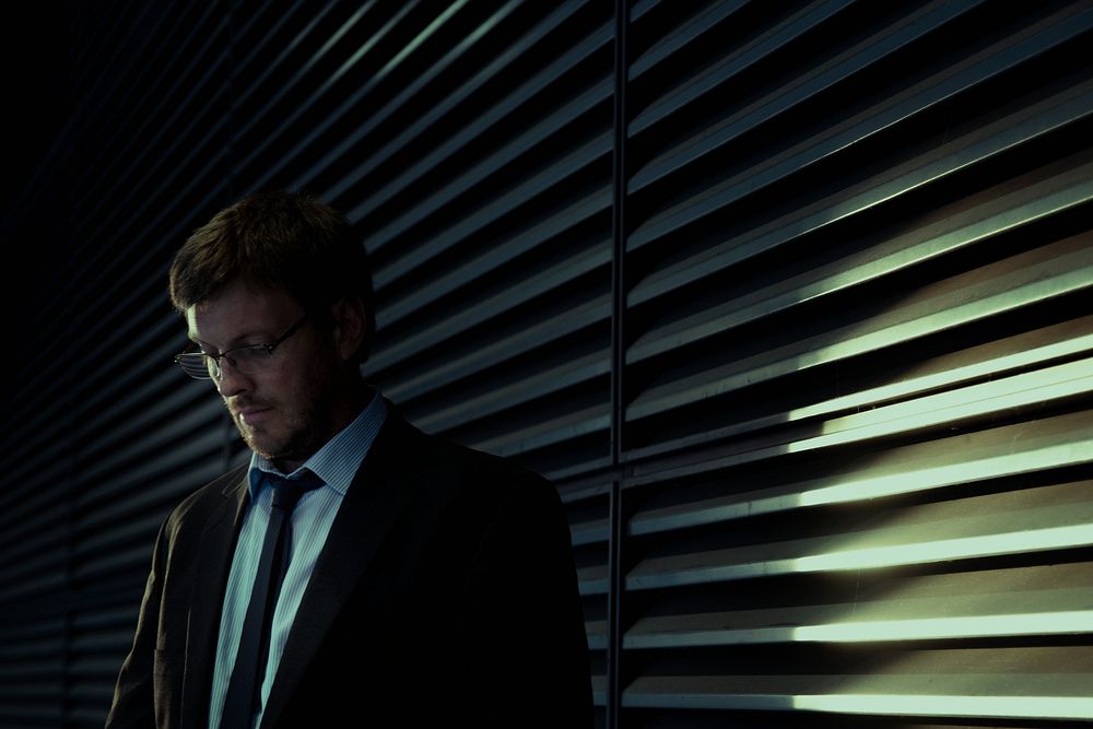 Businessman in suit standing near window