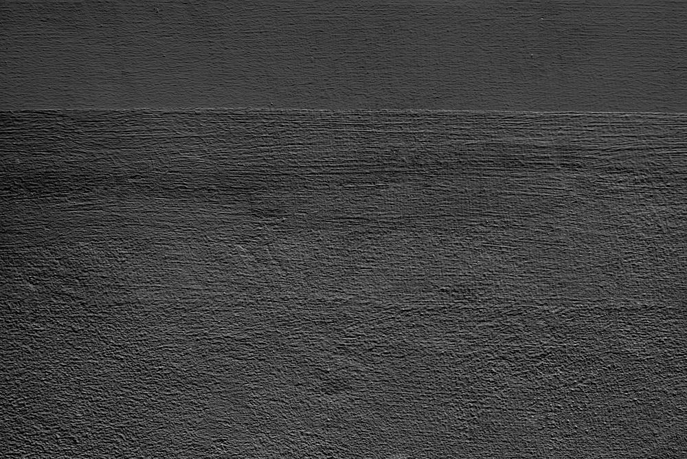 Dark gray plain concrete textured background