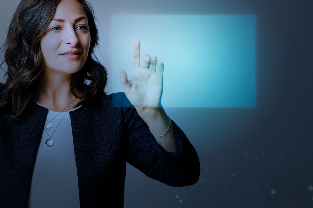 Senior businesswoman pointing on futuristic digital presentation