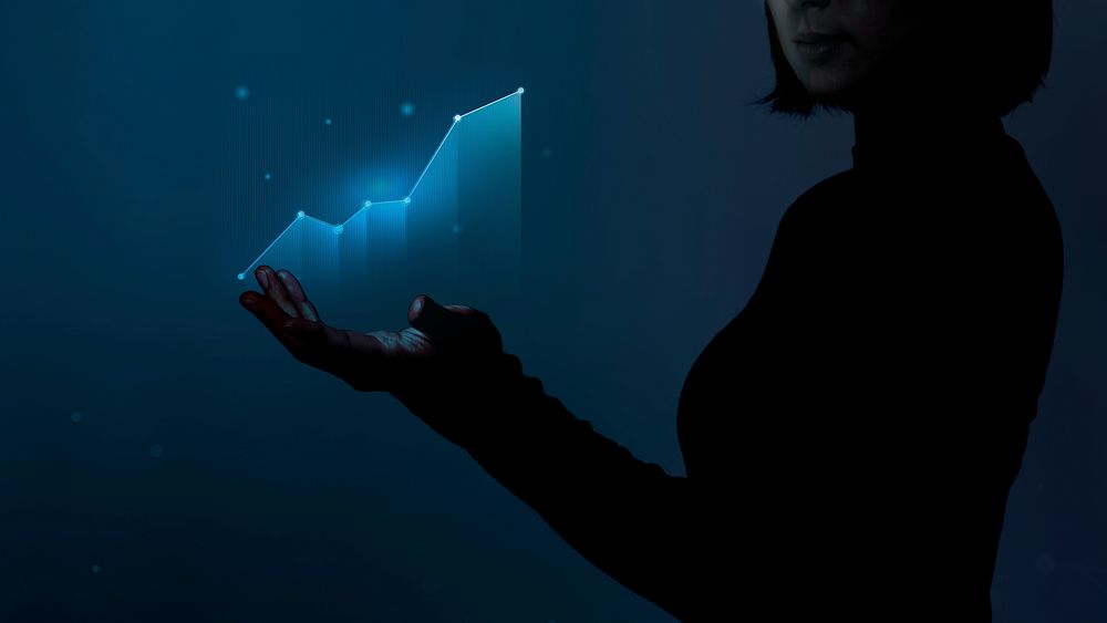 Business person holding a digitally generated growing graph