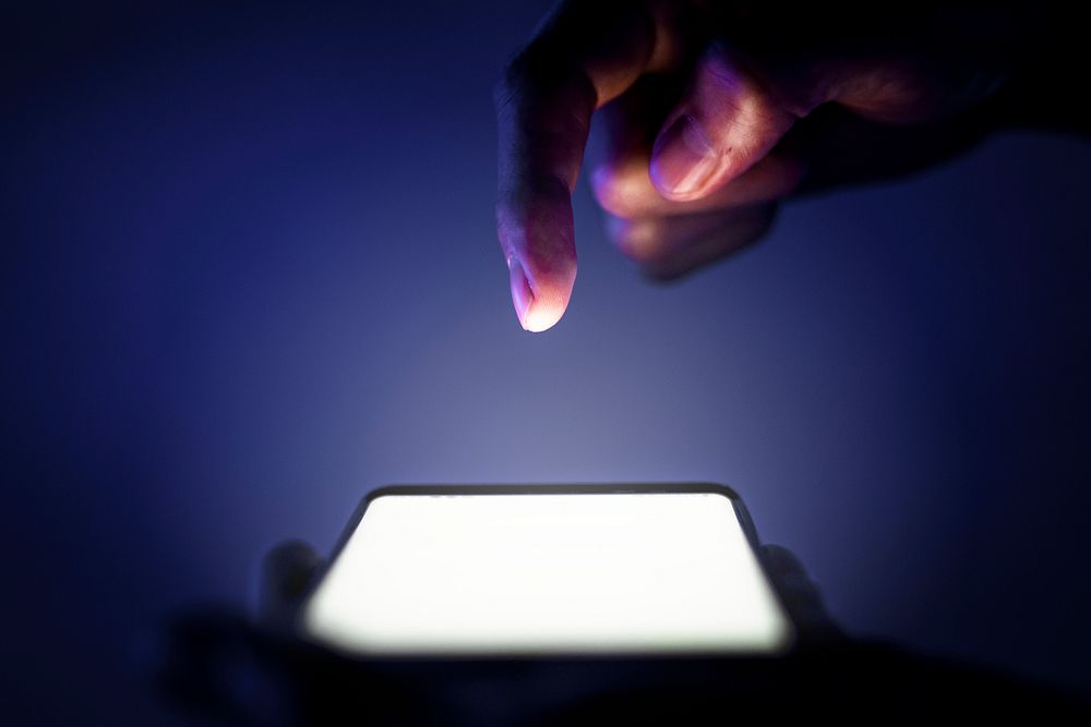 Phone screen shining in the dark