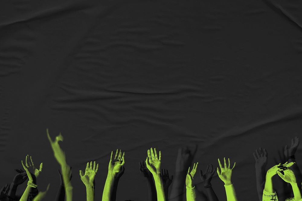 Vivid green arms raising up on black background