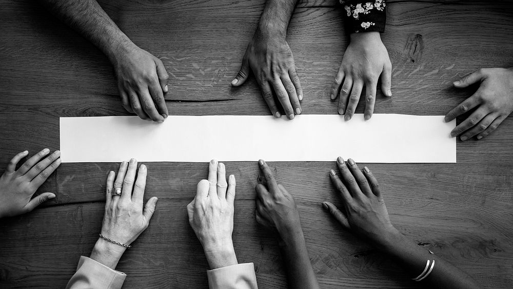 Black and white people's arms reaching out to mockup banner wallpaper