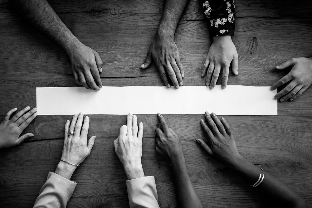 Diverse hands touching white paper mockup