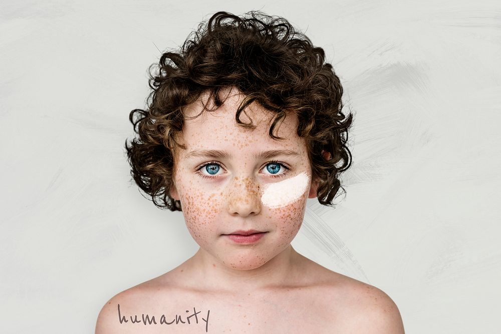 Humanity campaign psd curly haired boy with freckles and white paint on his cheek