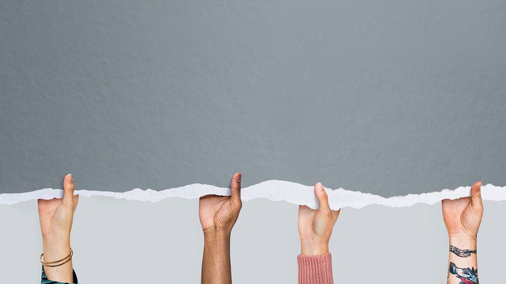 Multicultural hands holding a gray mockup paper wallpaper
