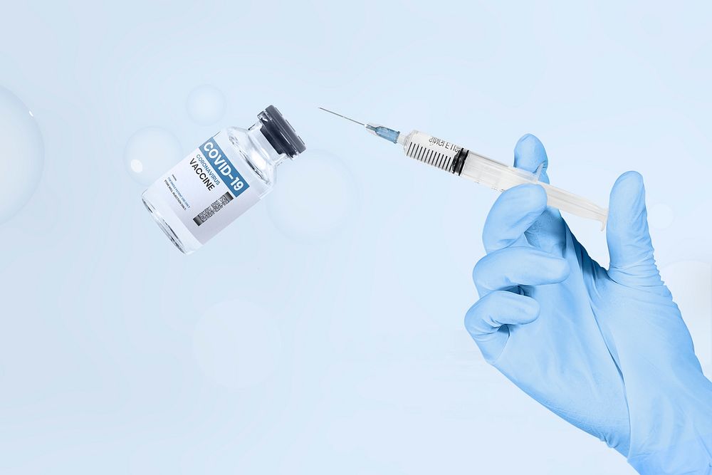 Hand  holding psd syringe and vaccine vial