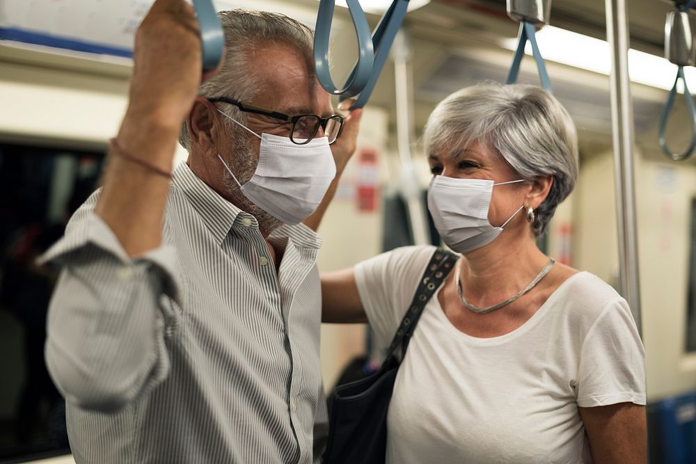 Couple wearing masks in train in the new normal