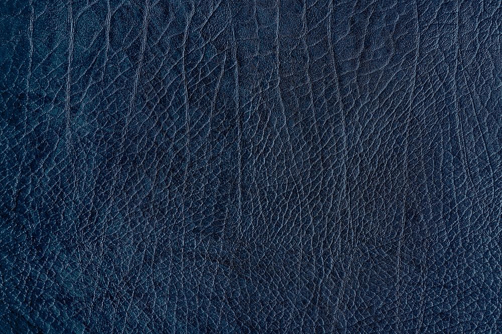 Dark blue creased leather textured background