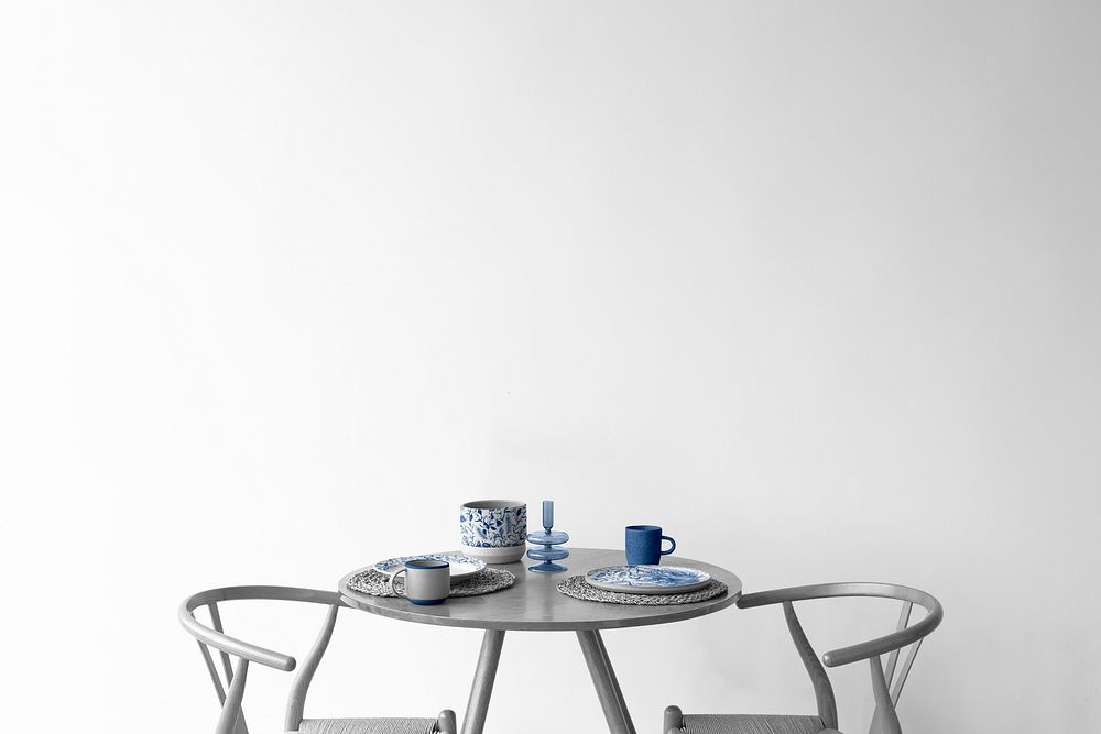 Wall mockup psd by the table with porcelain tableware on top