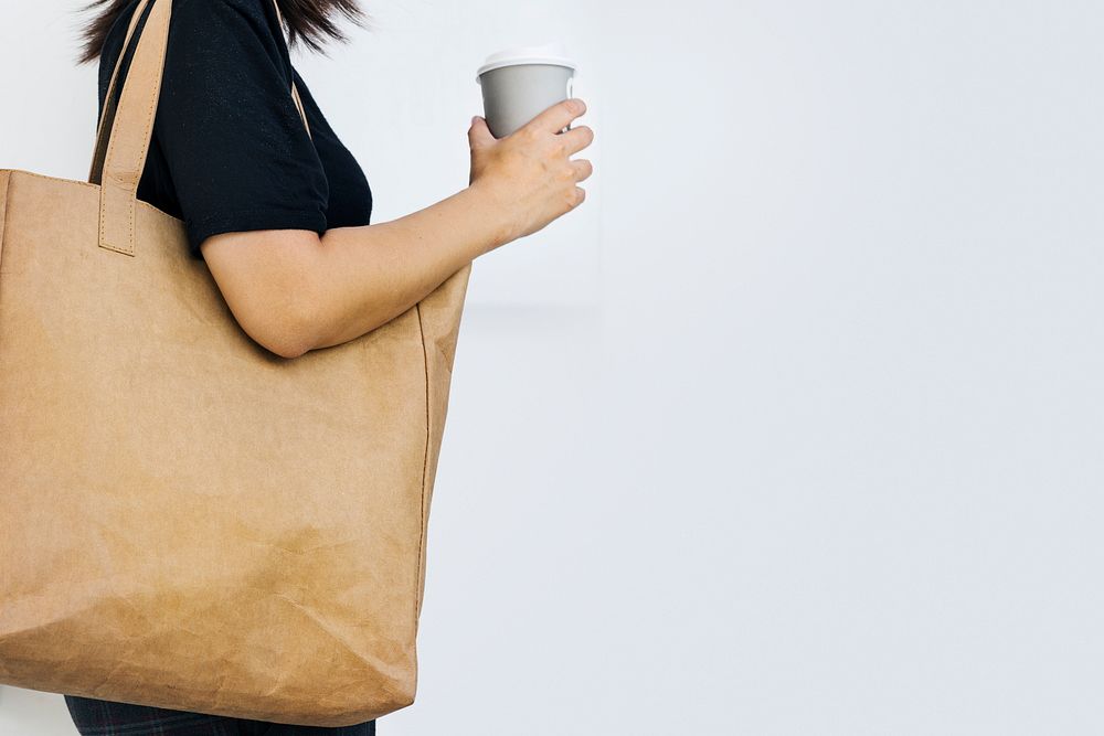 Environmentalist woman using eco-friendly tote bag photo with design space