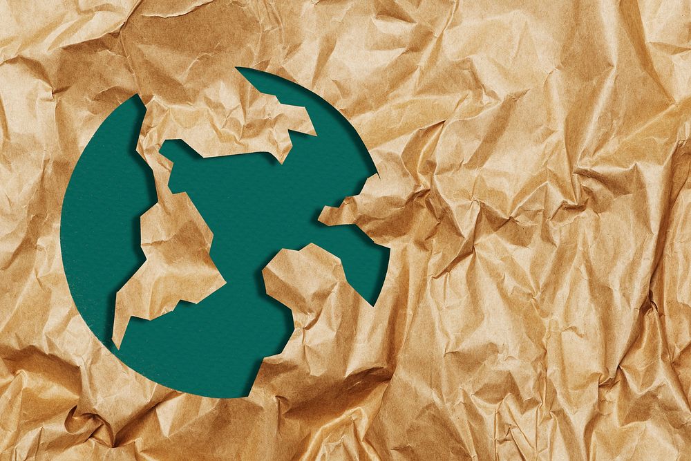 Green earth on ripped brown paper craft background