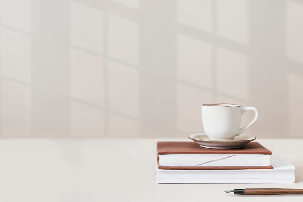 Wall background psd with coffee cup on top of books