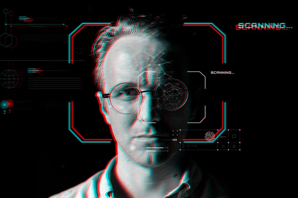 Man wearing smart glasses behind the virtual scanning technology in glitch effect 
