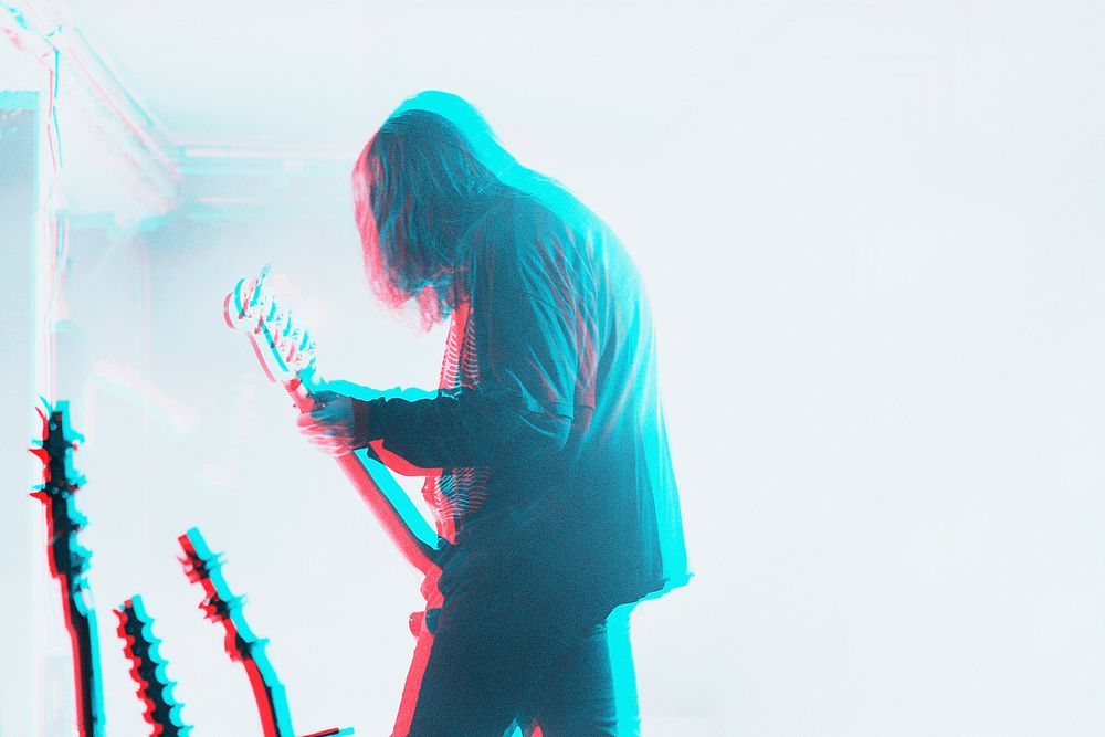 Bassist performing in a concert in double color exposure effect
