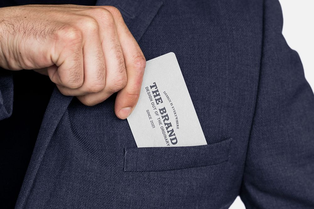 Business card mockup in a business man's hand psd