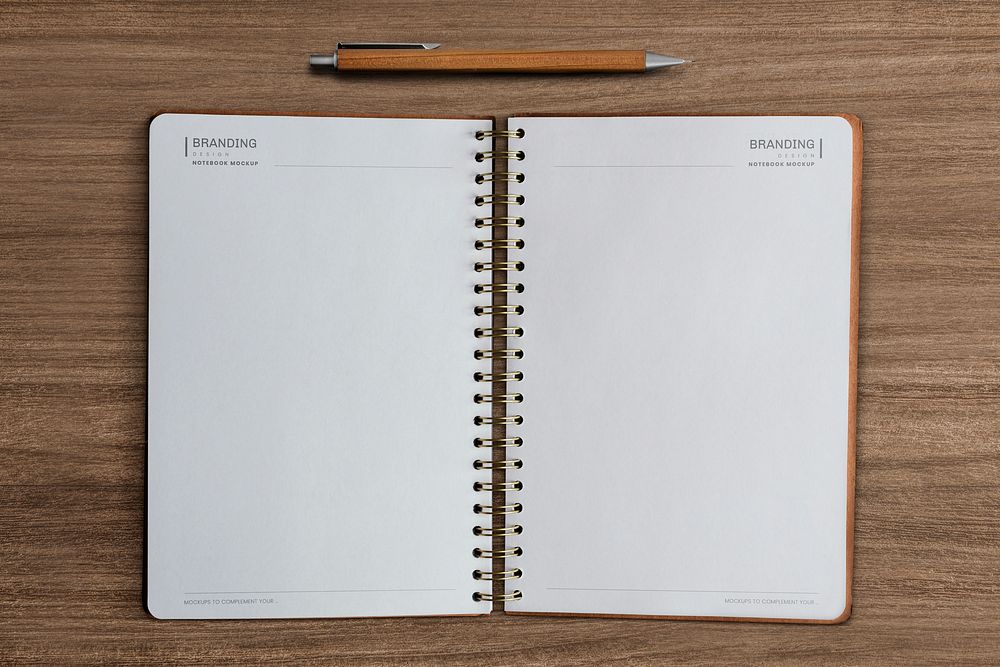 Opened notebook pages mockup psd on wooden background