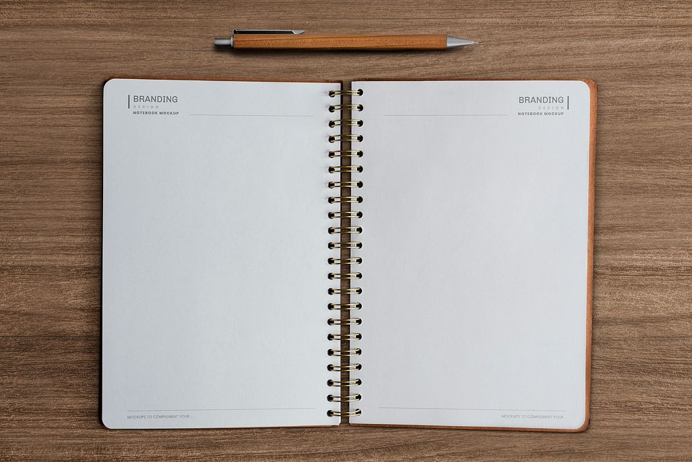 Empty notebook pages on wooden background