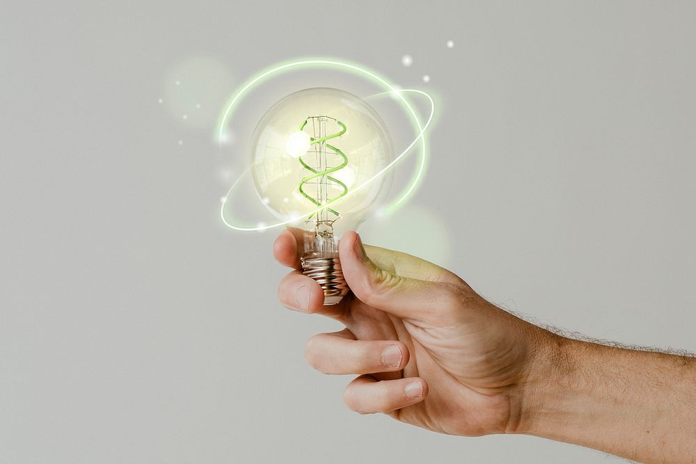 Green energy psd with hand holding an environmental light bulb background