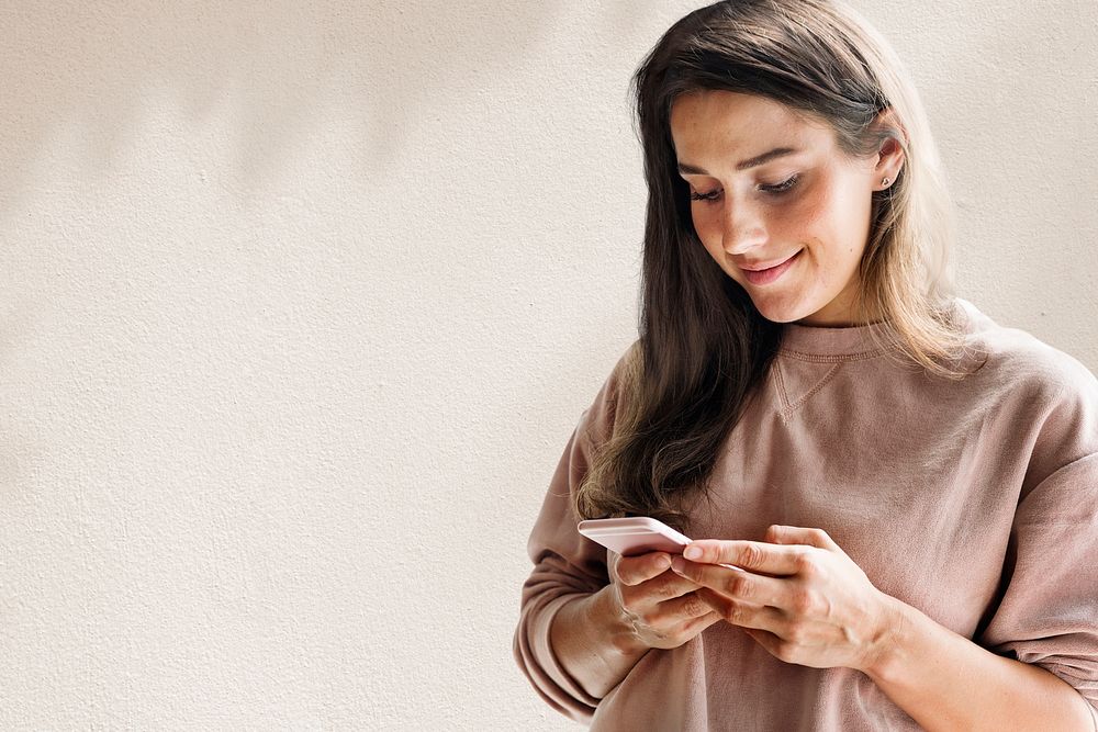 Woman holding smartphone background psd in the new normal with leaf shadow