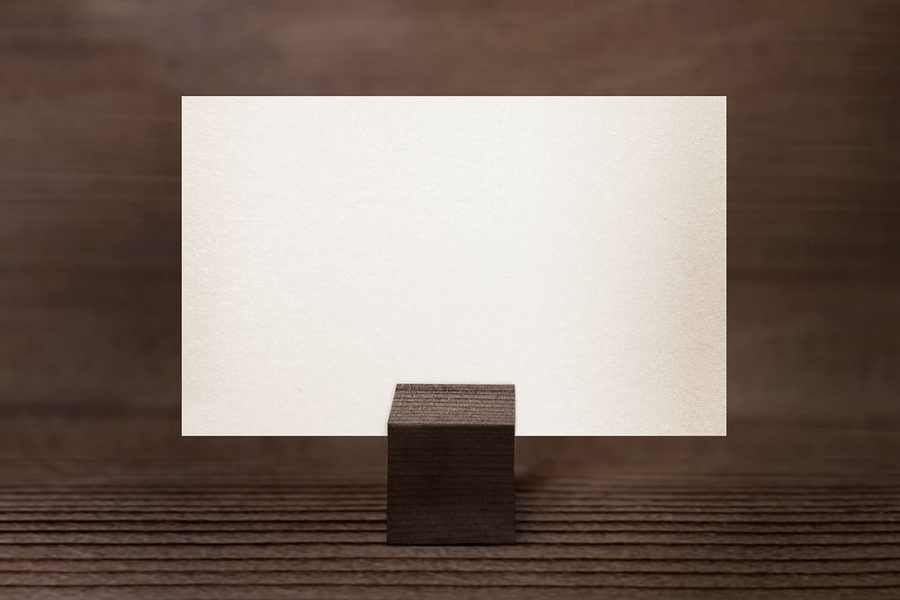 Blank name card on wooden background