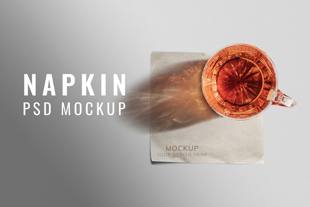 Paper napkin mockup psd with whiskey glass on top