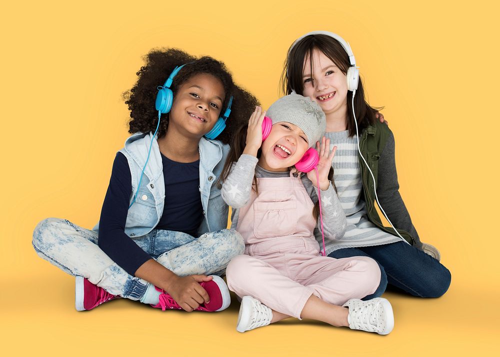 Group of Little Girls Studio Smiling Wearing Headphones and Winter Clothes