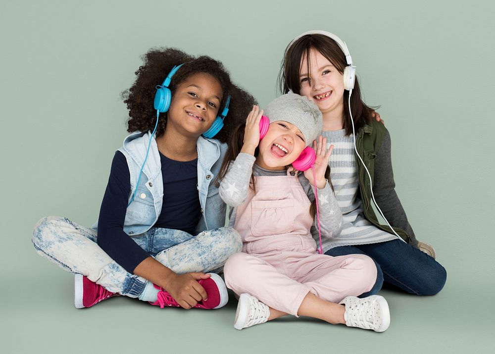 Group of Little Girls Studio Smiling Wearing Headphones and Winter Clothes