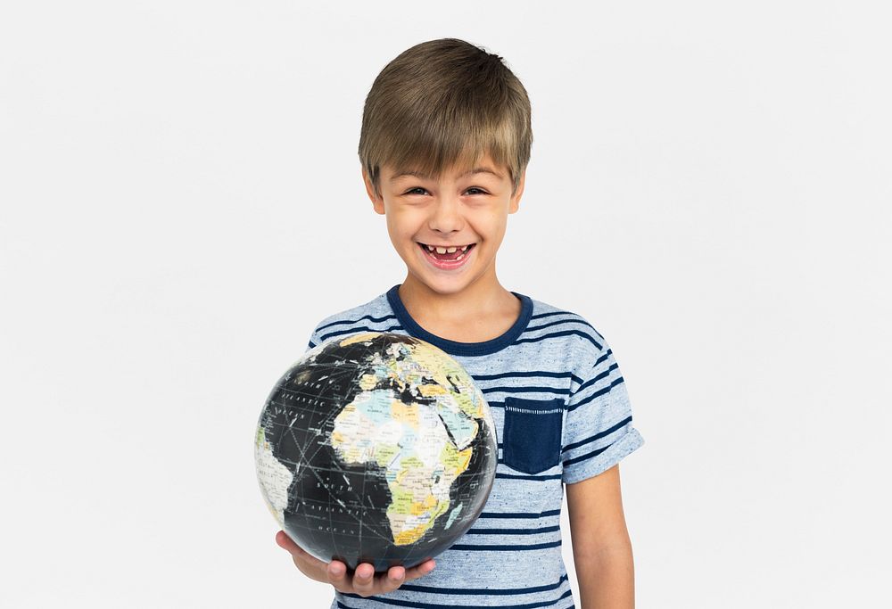 Smiling young boy holding a globe