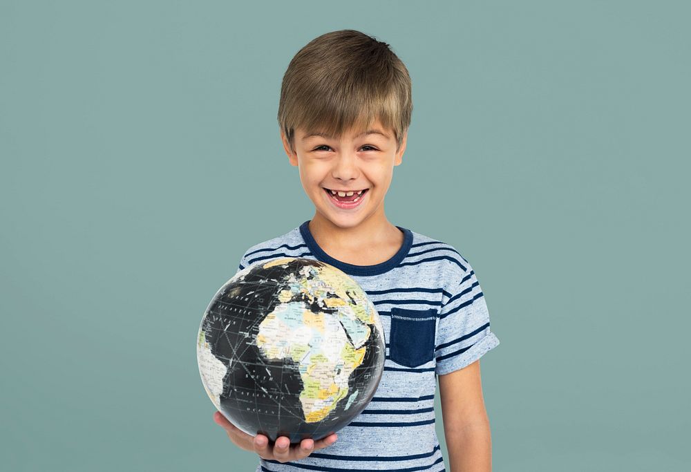 Portrait of a young boy holding a globe