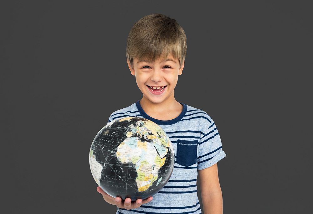 Portrait of a young boy holding a globe