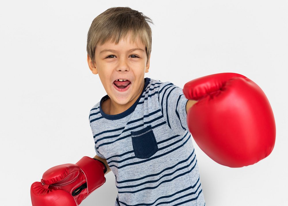 Young boy punching with boxing gloves
