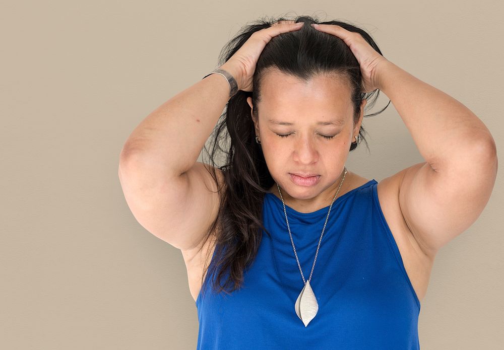Portrait of a woman holding her hair looking stressed out
