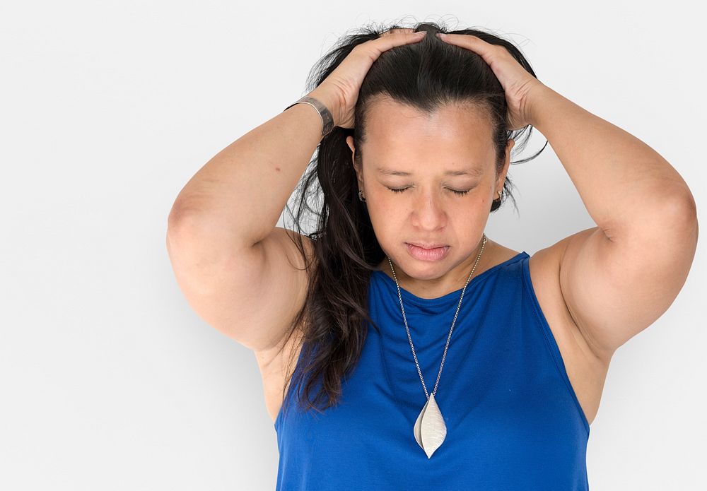 Portrait of a woman holding her hair looking stressed