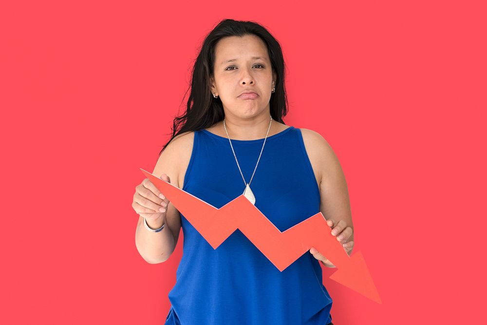 Portrait of a woman holding a downward graph arrow