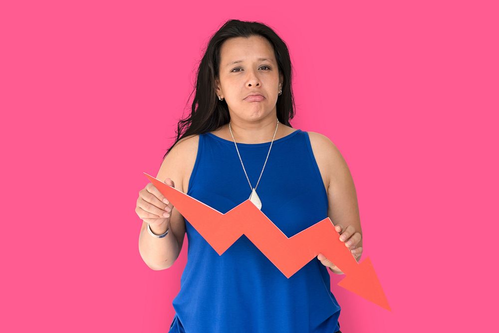 Portrait of a woman holding a downward graph arrow