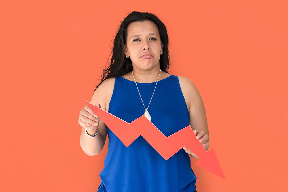 Portrait of a woman holding a downward graph arrow