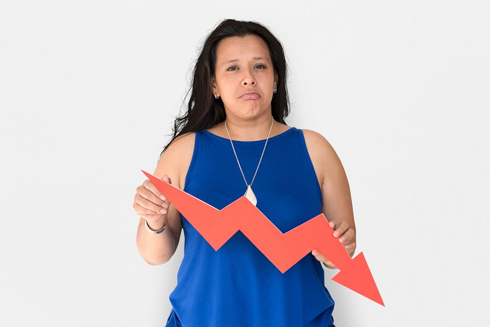 Portrait of a woman holding a downward graph arrow