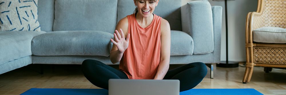 Woman taking an online yoga class during coronavirus quarantine