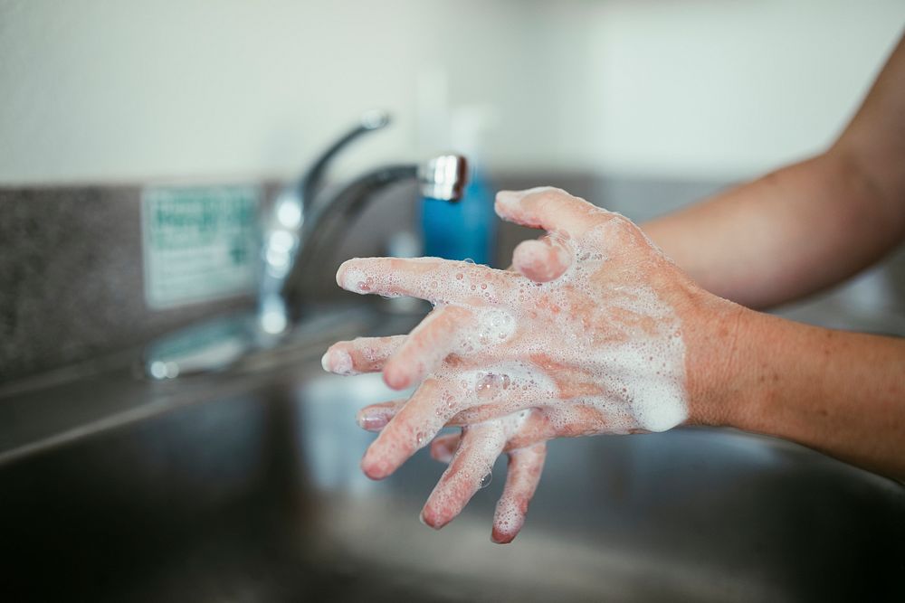 Woman washing her hands with soap during coronavirus pandemic