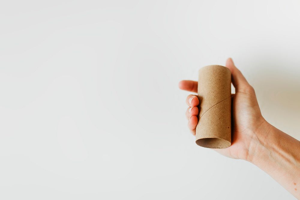 Woman holding an empty toilet paper roll during coronavirus pandemic