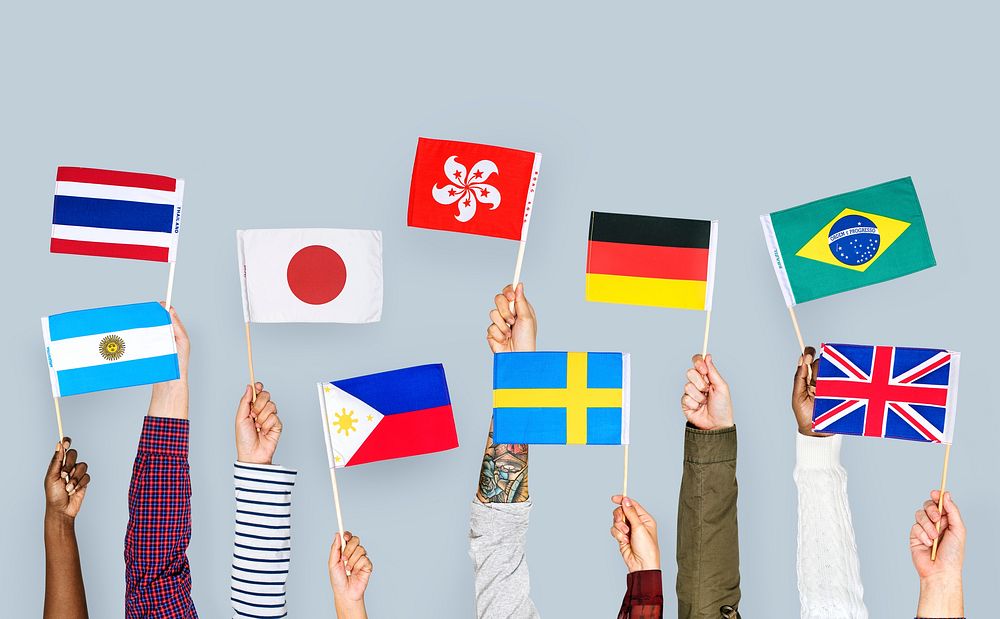 Hands holding international flags
