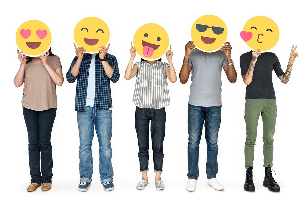 Diverse people holding happy emoticons