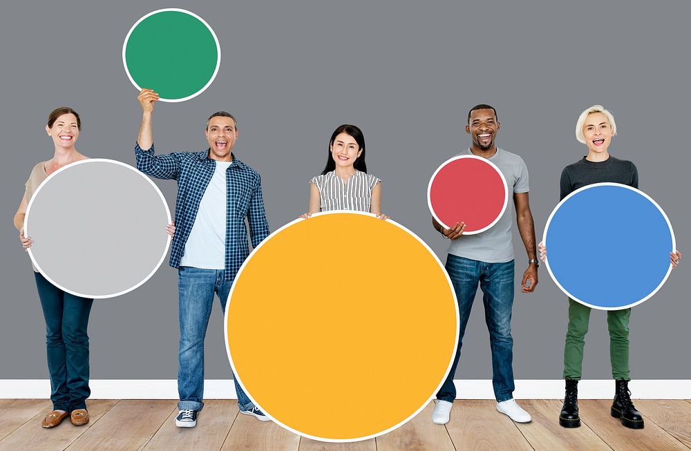 Happy people holding colorful round boards