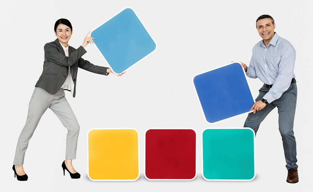 Happy people holding colorful blocks