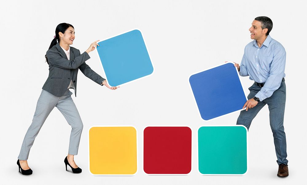 Happy people holding colorful blocks