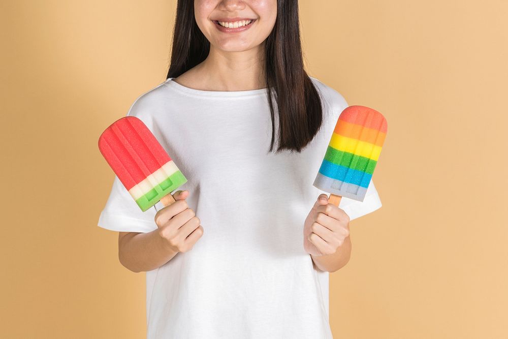 Woman with colorful ice pops in summertime