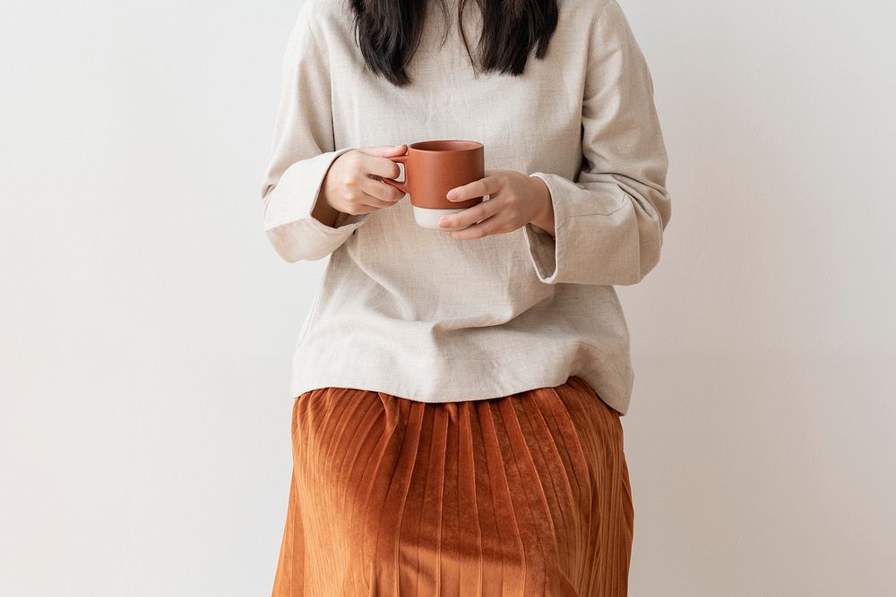 Asian woman with a cup of coffee in her hand
