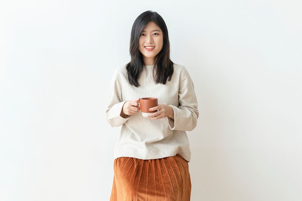 Asian woman with a cup of coffee in her hand